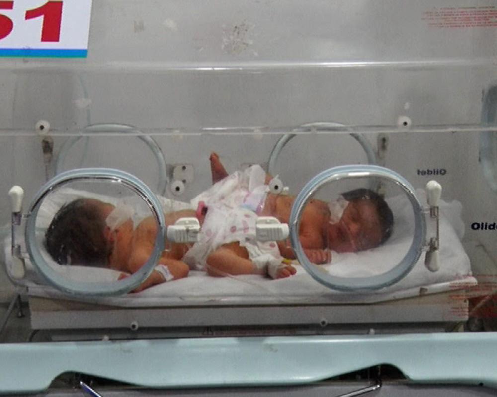 Two babies lie in an incubator in the Lady Reading Hospital in Peshawar, Pakistan. Photo by Wisal Yousafzai. 