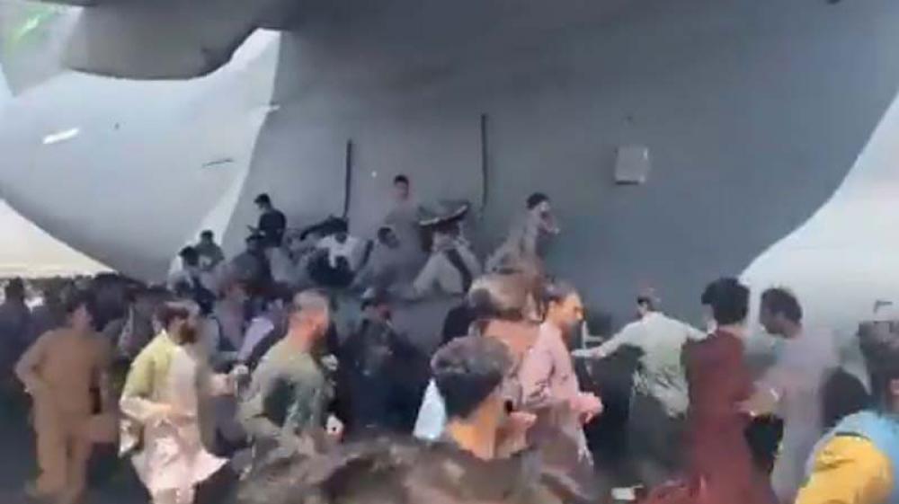 Afghanistan conflict: Desperate scenes at Kabul airport as people cling to moving C-17 aircraft