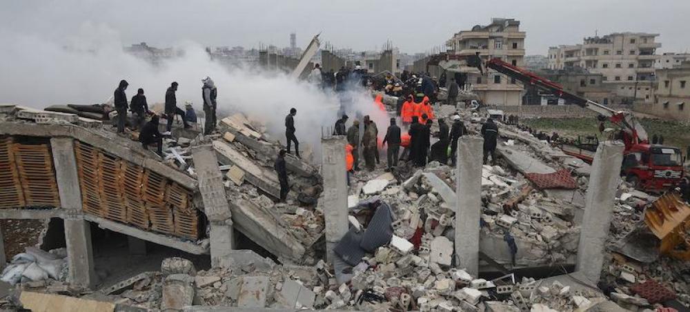 UNOCHA/Ali Haj Suleiman Rescue workers look for survivors in a building in Samada, Syria destroyed by the February 6 earthquake. 