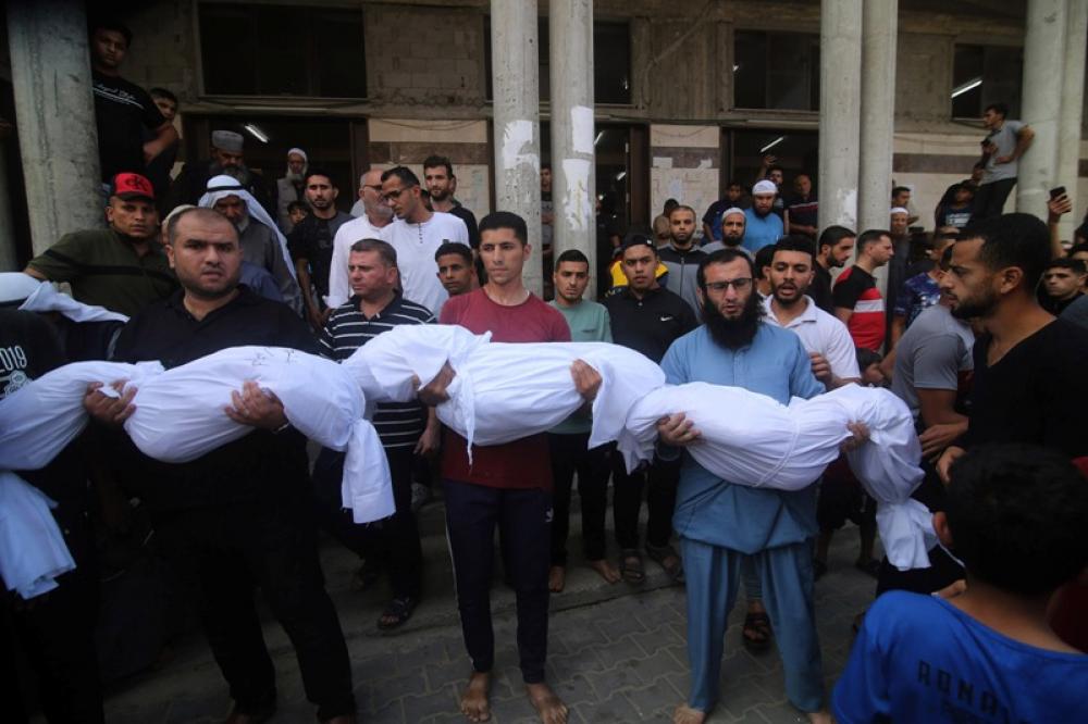 People hold the bodies of children died in an Israeli airstrike in the southern Gaza Strip city of Rafah on Oct. 8, 2023. Photo Courtesy:UNI/Xinhua