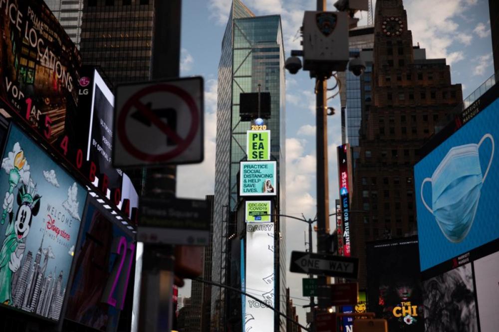 Billboards at Times Square in New York encourage people to maintain social distancing