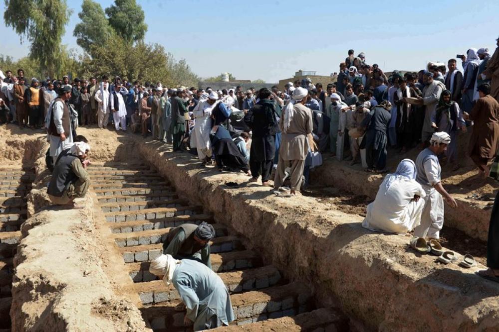 People digging graves for victims of a suicide explosion in Afghanistan