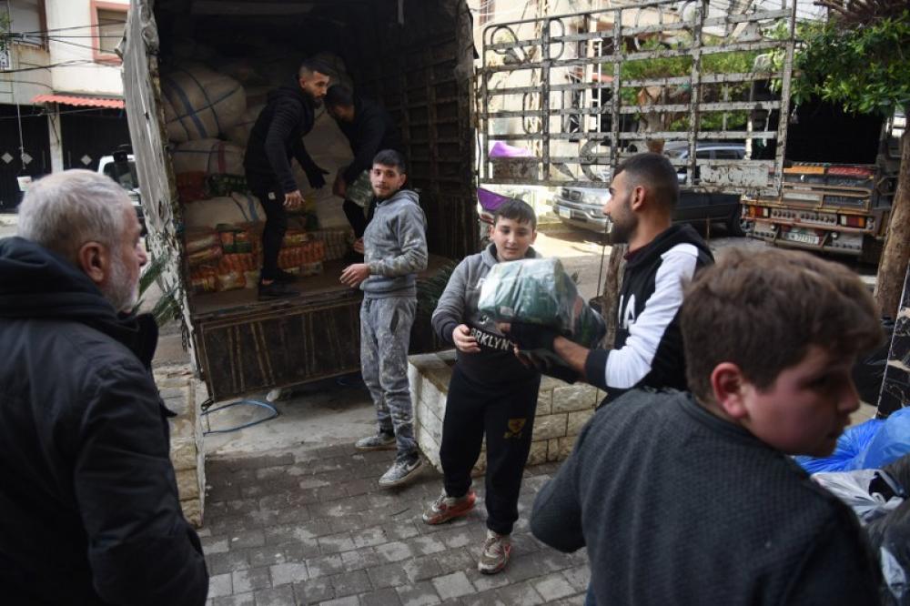 Volunteers loading relief material for quake-hit Syria in Lebanon